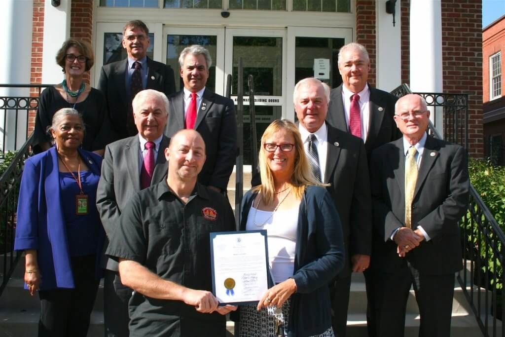 he Commissioners and Tourism Director Lisa Challenger join with Assawoman Bay Brewing Company Head Brewer Jason Weissberg (front row, from left) and ShoreCraftBeer.com creator Ann Hillyer to proclaim October as Shore Craft Beer Month in Worcester County and to promote the capstone event, Shore Craft Beer Fest, on October 29, as well as other activities in October that promote the County and the surrounding region as a craft beer destination